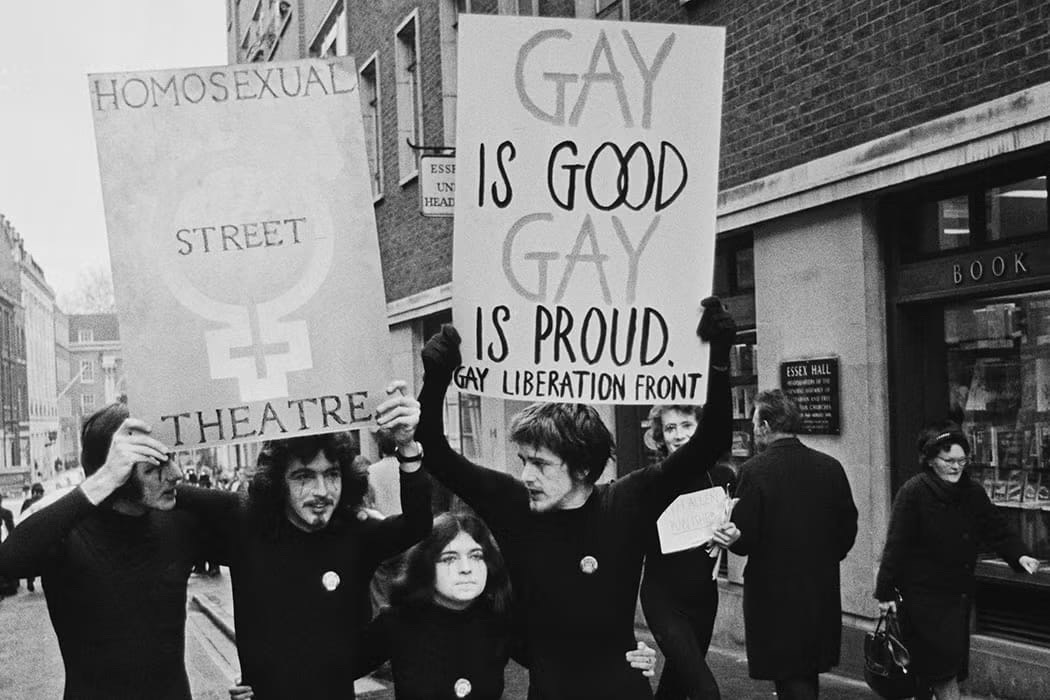Gay liberation activists holding protest signs