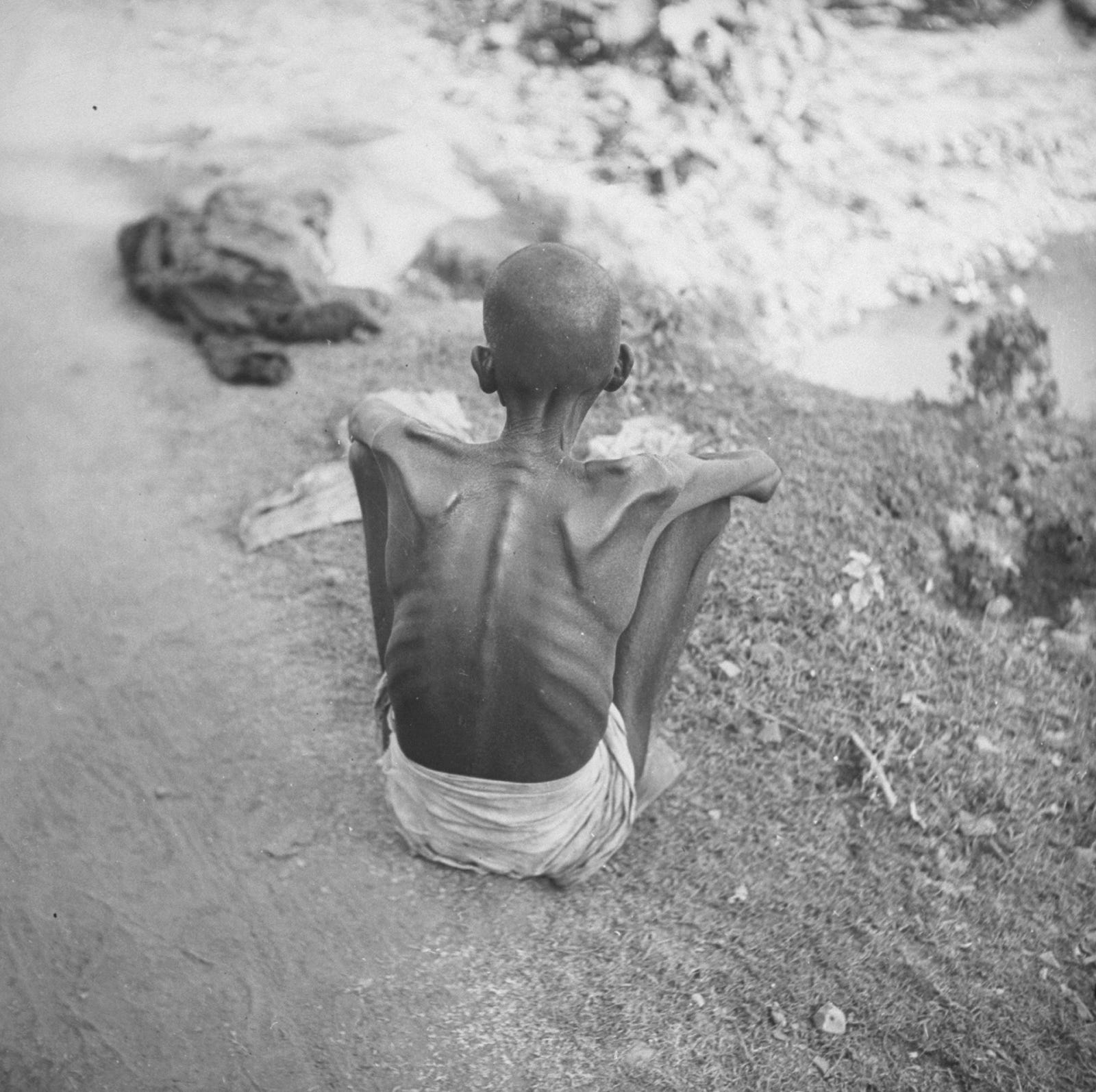 A solitary emaciated figure on a Bengal roadside during the 1943 famine