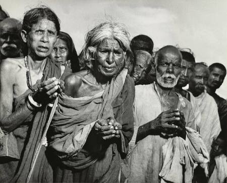 Older Bengali villagers with cupped hands waiting for relief during the Bengal Famine of 1943